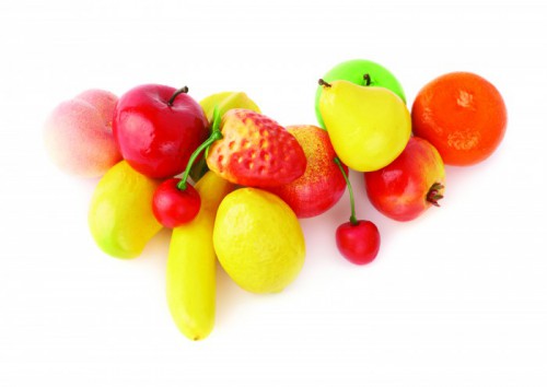 Pile of multiple artificial plastic fruits and berries